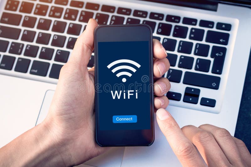 Connect to WiFi wireless internet network with smartphone at coffee shop or hotel with button on mobile device screen, free public stock image