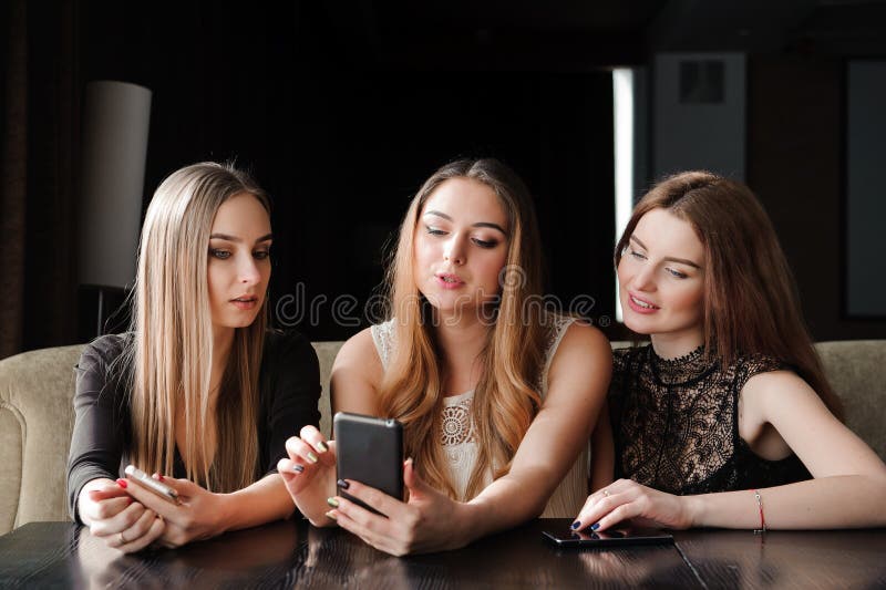 Always Connected, Internet Addiction, Young Girls in Cafe Looking at ...