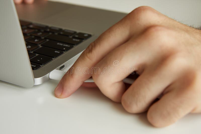 Connecting cable to laptop close-up royalty free stock images