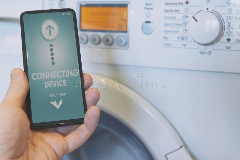 Connecting washing machine with smart phone stock photography Connecting washing machine with smart phone stock photography