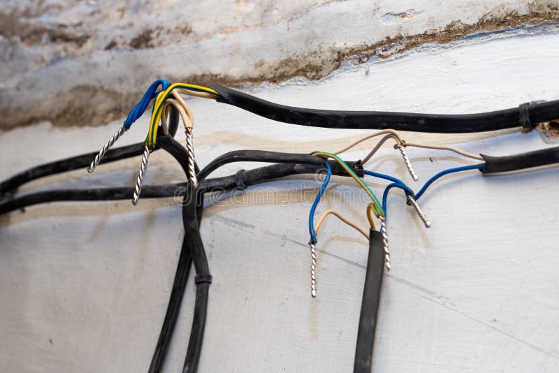 Connection of Wires Against the Background of a Wall in a House Under