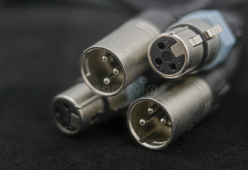 Close-up of three-pole xlr or canon connectors, both male and female, ready to be used. Close-up of three-pole xlr or canon connectors, both male and female, ready to be used