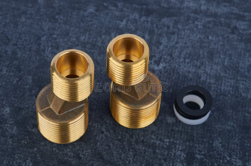 Eccentric connectors from brass for wall-mounted water faucet for installation, close-up, shallow depth of field. Eccentric connectors from brass for wall-mounted water faucet for installation, close-up, shallow depth of field