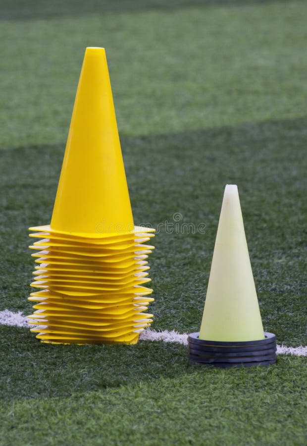 Yellow training cones on a training pitch. Yellow training cones on a training pitch