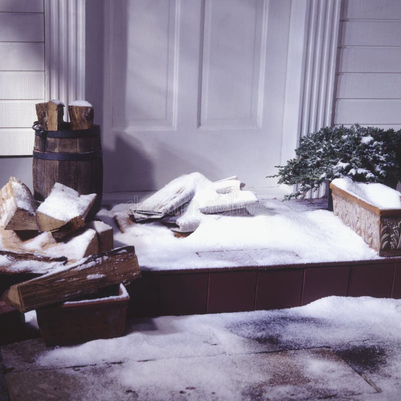 Newspaper delivery on snow covered winter porch. Newspaper delivery on snow covered winter porch