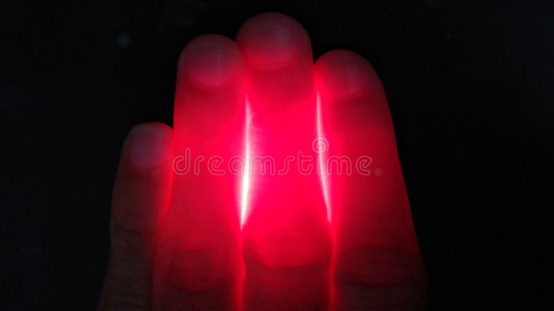 Hand over flashlight with red light effect, infrared Red light therapy concept. Hand over flashlight with red light effect, infrared Red light therapy concept