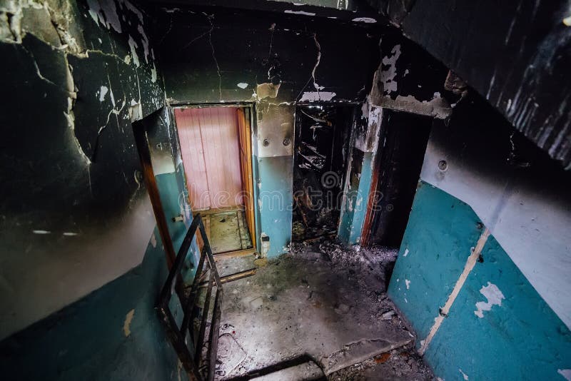 Consequences of Fire in Apartment Building. Burnt Staircase and Doors