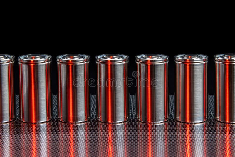 A consignment of new modern high-capacity lithium-ion cells. A prototype of new batteries on a steel surface illuminated with red