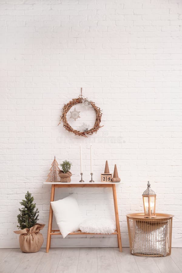 Console table with Christmas decoration near wall. Idea for festive interior royalty free stock images