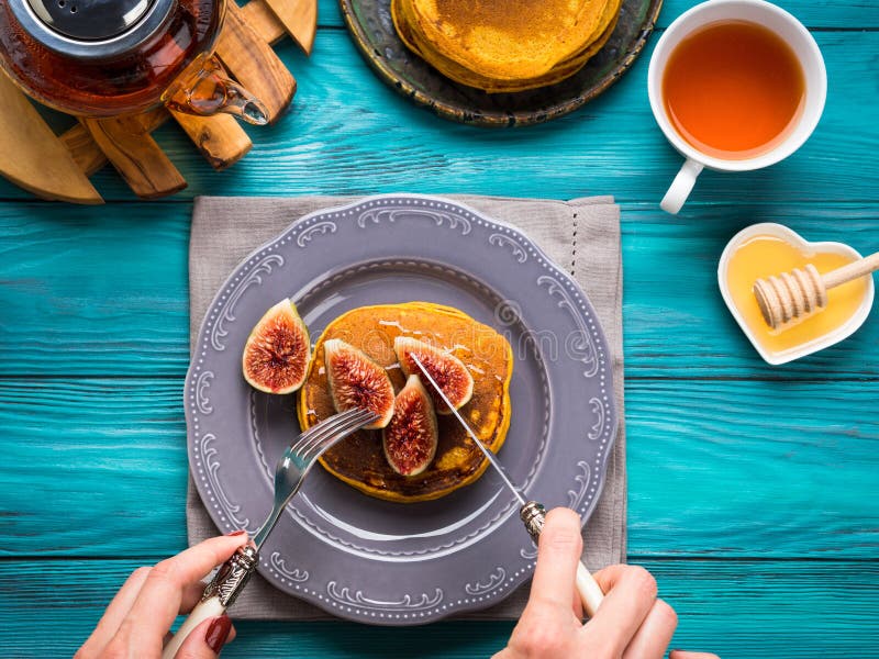 Consommation des crêpes de potiron avec les figues et le miel image libre de droits Consommation des crêpes de potiron avec les figues et le miel image libre de droits