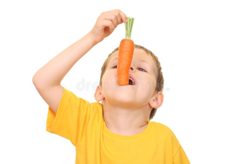 Five years old boy eating fresh carrot isolated on white. Five years old boy eating fresh carrot isolated on white
