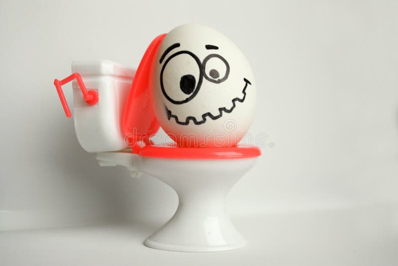 Constipation is a comical concept. an egg with a painted face sitting on the toilet. tuzhitsya. a tense smile. photo for your design. Constipation is a comical concept. an egg with a painted face sitting on the toilet. tuzhitsya. a tense smile. photo for your design.