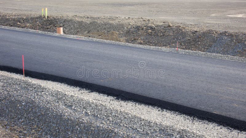 Construction Site of a Road at the End Environment Landscape, New Asphalt Surveying Stick. Construction Site of a Road at the End Environment Landscape, New Asphalt Surveying Stick