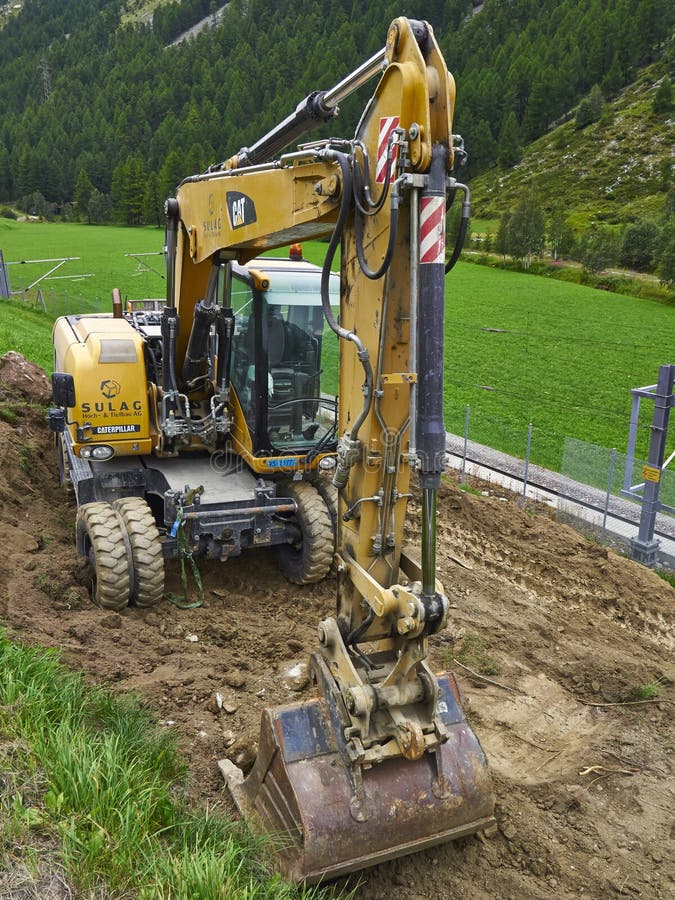 Backhoes Digging Sand with Shovels .from the River Editorial Photo