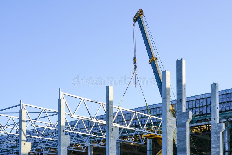 Construction of the body of a modern factory, assembly of metal trusses royalty free stock photos