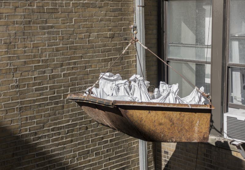 Construction Bucket with Bags of Debris Stock Photo Image of full