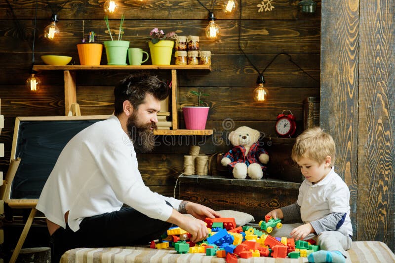 Construction concept. Father and child play with toy construction set. Father and son build structure model with royalty free stock photography Construction concept. Father and child play with toy construction set. Father and son build structure model with royalty free stock photography