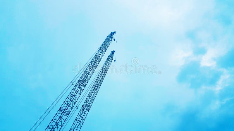 The construction crane on blue sky background, beautiful view landscape