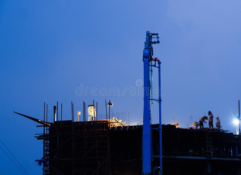 Construction Crane Truck Working on Structure at Night Editorial