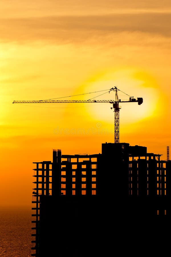 Construction cranes and building silhou