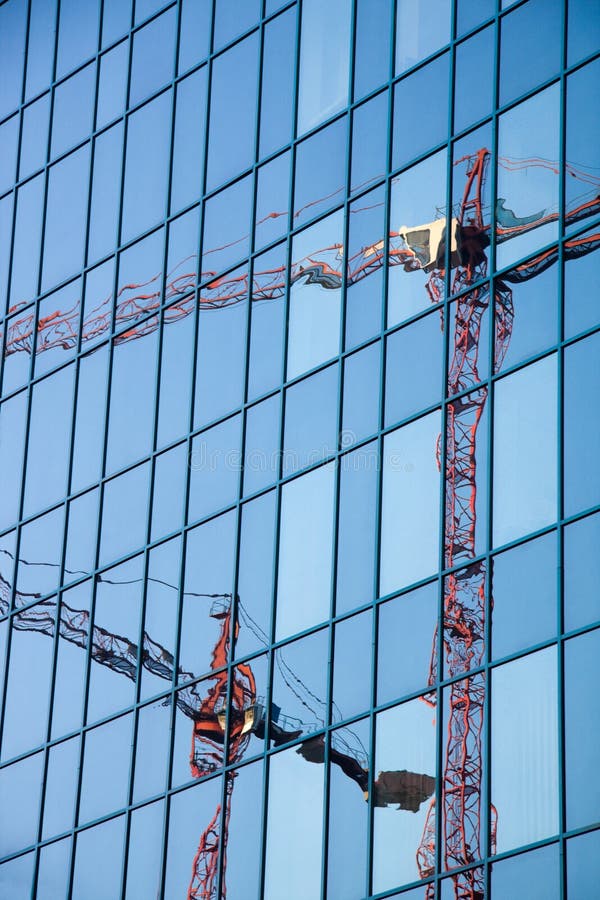 Construction cranes reflection