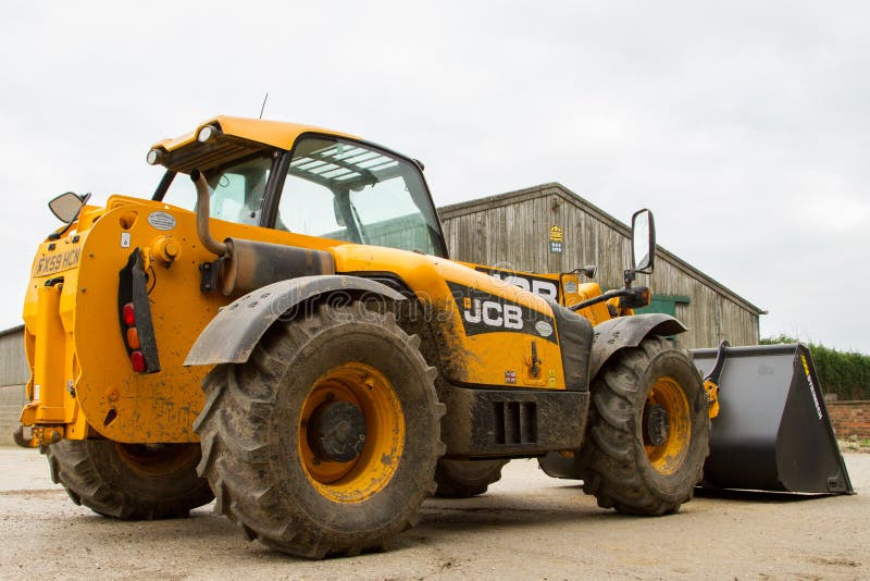 Construction Digger Loader in Farm Yard with Barn Editorial Stock Image