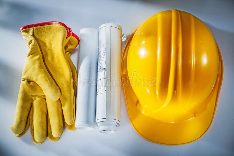 Construction drawings building helmet protective gloves on white royalty free stock photo