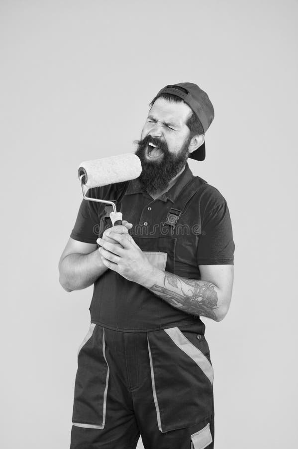Construction. engineer designer ready to paint wall. repair concept. bearded man worker sing in painting roller. hipster royalty free stock images Construction. engineer designer ready to paint wall. repair concept. bearded man worker sing in painting roller. hipster royalty free stock images