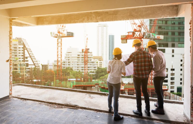 3 construction engineers working together discuss with blueprint royalty free stock images