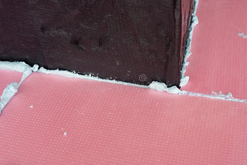 Construction Foam between Pink Extruded Styrofoam Sheets Stock Photo
