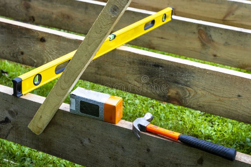 A Construction Hammer, a Box of Nails and a Construction Level Stock ...