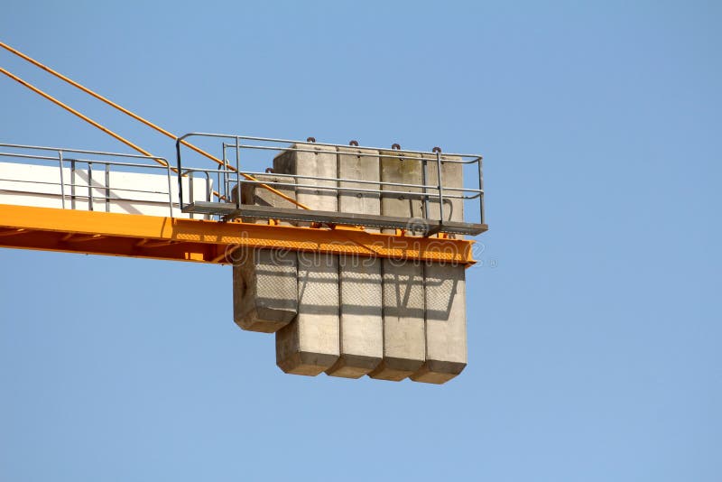 Construction industry tower crane or TC concrete counterweight held in place with strong metal construction