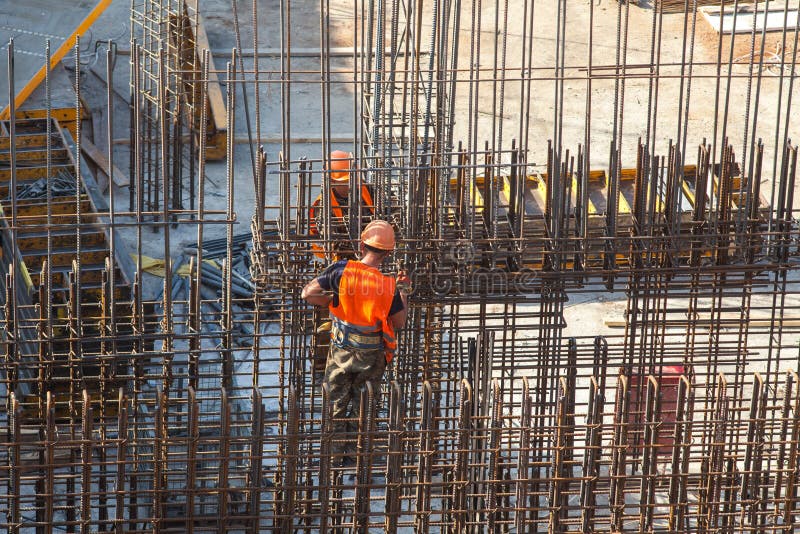Construction of a large commercial building. Worker connects the armature at the construction site. royalty free stock photos Construction of a large commercial building. Worker connects the armature at the construction site. royalty free stock photos