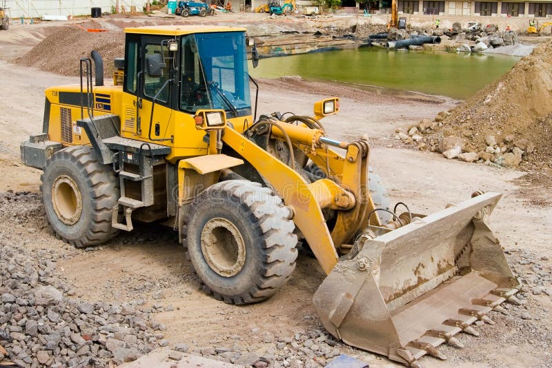 Construction loader at a job site ready to work. Track hoe construction excavator stock images, royalty-free photos and pictures