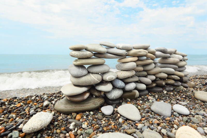 Construction of many pebbles on a sea coast