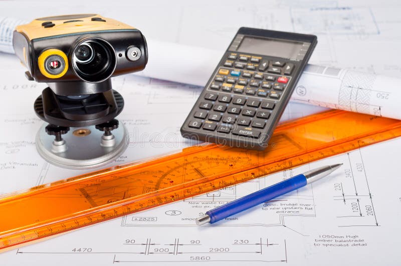 Building plans with laser distance measurement device and calculator. Building plans with laser distance measurement device and calculator