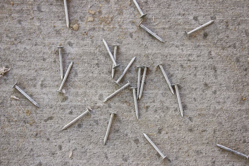 Construction Nails on Concrete Stock Photo - Image of construction