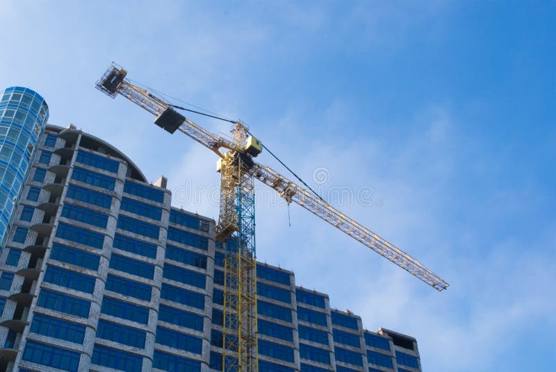 Construction - new blue glass building and crane