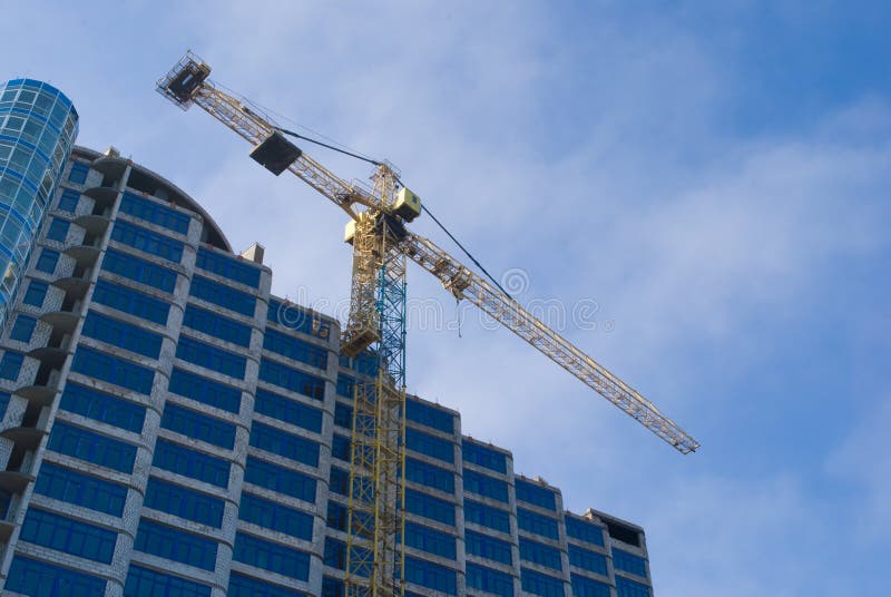 Construction - new blue glass building and crane