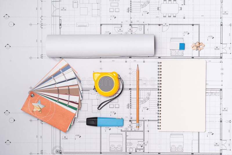 Construction Plans with Helmet and Drawing Tools on Blueprints Stock