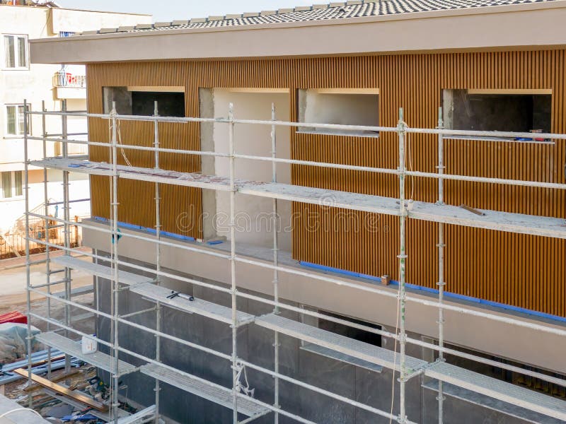 Construction Scaffolding Built on a New Apartment Building. New