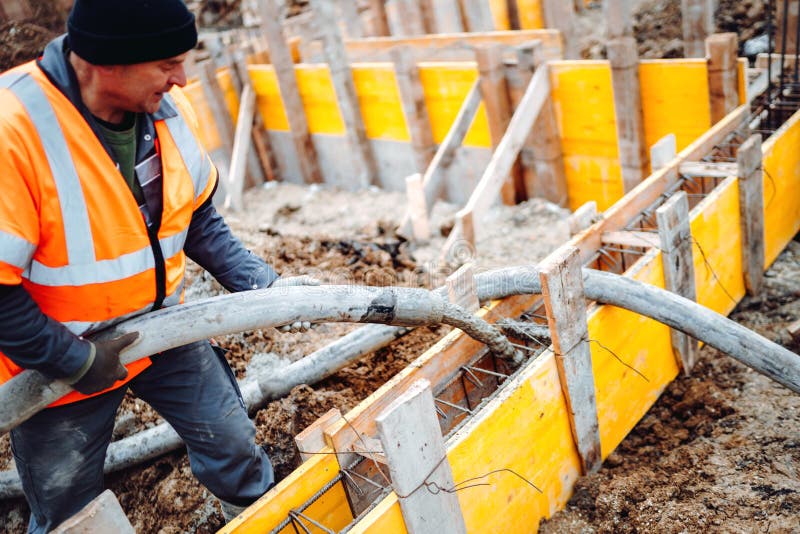 Construction site - building concrete slabs at house construction and pouring cement on reinforcement bars