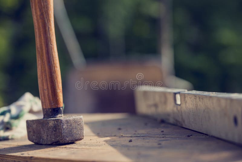 Construction Site concept with a wooden mallet and level stock image