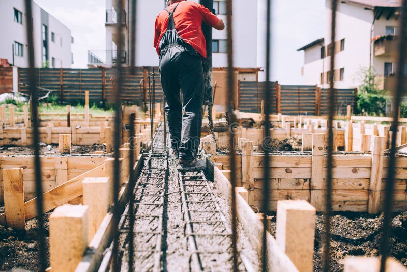 Construction site details - building foundation and pouring concrete on reinforcement bars