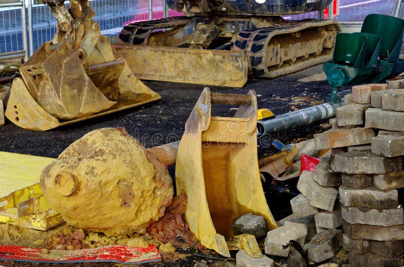 Construction site in downtown at night with excavator shovel, excavator and construction equipment stock photo Construction site in downtown at night with excavator shovel, excavator and construction equipment stock photo