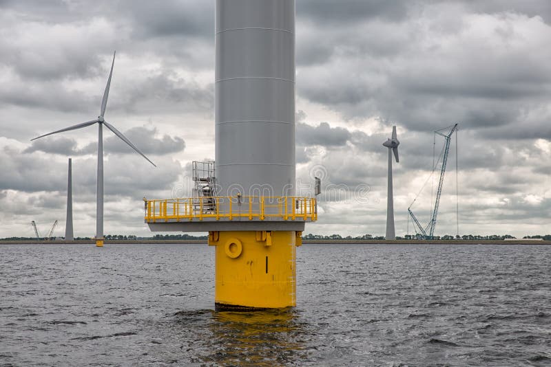 Construction site offshore windfarm near Dutch coast with cloudy sky. This park in the lake IJssselmeer near Urk is the biggest windfarm of the Netherlands