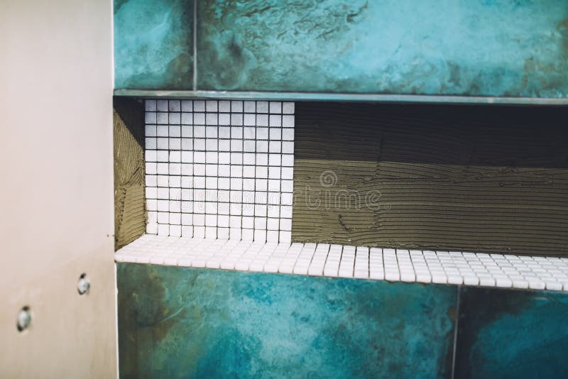 Details of construction site, renovation and improving bathroom area. Shower area with mosaic marble pattern installation close up. Bricklayer tiler stock images, royalty-free photos and pictures