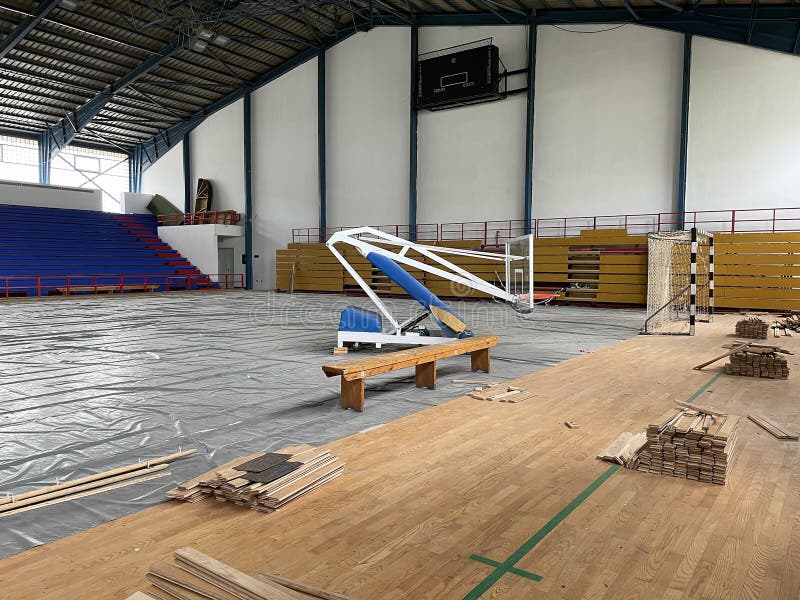 Construction site of sports hall, basketball court renovation, school gym indoor changing hardwood parquet flor and