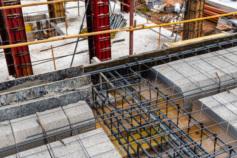 Construction Site with Steel Formworks and Reinforcing Bars for Stock