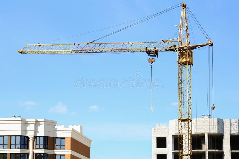 Construction Site with Tower Crane Near Unfinished Building Stock Photo